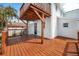 Side view of the back deck featuring a covered area with lighting and access to the home's back door at 13148 3Rd E St, Madeira Beach, FL 33708