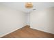 Bedroom showcasing modern light fixture and wood-look laminate flooring at 13148 3Rd E St, Madeira Beach, FL 33708