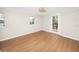 Light-filled bedroom with wood floors, windows, and a glass door at 13148 3Rd E St, Madeira Beach, FL 33708