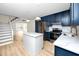 Open kitchen and stairway with stainless steel appliances and white countertops at 13148 3Rd E St, Madeira Beach, FL 33708