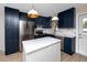 Modern kitchen boasts an island, stainless steel appliances, and stylish white countertops at 13148 3Rd E St, Madeira Beach, FL 33708