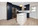 Kitchen features blue cabinets, an island, and stainless steel appliances at 13148 3Rd E St, Madeira Beach, FL 33708