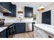 Well-lit kitchen showcases stainless steel appliances, dark wood cabinets and white countertops at 13148 3Rd E St, Madeira Beach, FL 33708