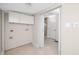 Bright laundry room with white cabinets and tile floors, conveniently located near the bathroom at 13148 3Rd E St, Madeira Beach, FL 33708