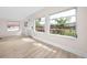 Sun-drenched living room featuring new flooring, large windows, and neutral walls, creating a bright and airy space at 13148 3Rd E St, Madeira Beach, FL 33708