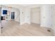 Bright, open living room with hardwood floors and views into the kitchen and stairway at 13148 3Rd E St, Madeira Beach, FL 33708