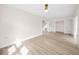 Expansive living room showcasing new light-toned flooring and modern ceiling fan and freshly painted walls at 13148 3Rd E St, Madeira Beach, FL 33708