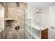 Shower with tan tile and glass block wall with brown vanity in the bathroom at 13148 3Rd E St, Madeira Beach, FL 33708