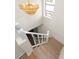 Staircase featuring a decorative chandelier and white railing, leading to the lower level at 13148 3Rd E St, Madeira Beach, FL 33708