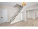 Stairway with white railings and a modern light fixture that leads to the upper level at 13148 3Rd E St, Madeira Beach, FL 33708