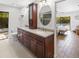 Bathroom featuring double vanity with modern fixtures, and view of the pool at 13501 Avista Dr, Tampa, FL 33624