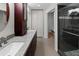 Bathroom featuring a double vanity with granite countertop and modern glass shower at 13501 Avista Dr, Tampa, FL 33624