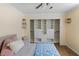 Bedroom featuring a ceiling fan and a large closet with custom shelving at 13501 Avista Dr, Tampa, FL 33624
