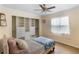Bedroom features a ceiling fan and a large closet with custom shelving at 13501 Avista Dr, Tampa, FL 33624