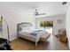Bright bedroom with tiled floors offers view to the pool, queen bed, and ceiling fan at 13501 Avista Dr, Tampa, FL 33624