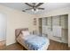 Bedroom features a ceiling fan and a closet with custom shelving at 13501 Avista Dr, Tampa, FL 33624