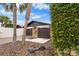 Home exterior with a driveway, stone accents, and lush greenery, creating a welcoming entrance at 13501 Avista Dr, Tampa, FL 33624