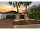 Exterior view of home with palm trees, brick driveway and attractive landscaping at sunset at 13501 Avista Dr, Tampa, FL 33624