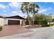 Charming home exterior featuring a brick driveway, mature palm trees, and attractive landscaping at 13501 Avista Dr, Tampa, FL 33624