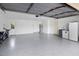 Spacious garage with epoxy flooring, ample storage space, and a convenient layout for parking vehicles at 13501 Avista Dr, Tampa, FL 33624