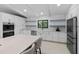 Bright kitchen featuring an island with seating and stainless steel appliances at 13501 Avista Dr, Tampa, FL 33624