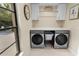 Bright laundry room with modern appliances and window overlooking the backyard at 13501 Avista Dr, Tampa, FL 33624