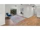 Bright living room featuring a comfortable chair, modern decor, and wood-look floors at 13501 Avista Dr, Tampa, FL 33624