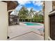 Backyard pool and screened lanai with outdoor dining area is surrounded by lush landscaping at 13501 Avista Dr, Tampa, FL 33624