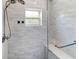 Modern shower featuring white subway tile, glass enclosure, and a dual shower head at 13501 Avista Dr, Tampa, FL 33624