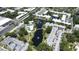 From above, discover condos with a central pond, swaying trees, and a pool, offering a blend of nature and comfort at 14130 Rosemary Ln # 3202, Largo, FL 33774
