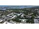 Aerial view showcases the condo community featuring central water features, swimming pool, and manicured landscaping at 14130 Rosemary Ln # 3202, Largo, FL 33774