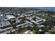 An aerial perspective showcases condos with a pond, swaying trees, and a pool, blending nature and relaxation in the community at 14130 Rosemary Ln # 3202, Largo, FL 33774