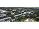 An elevated shot showing the proximity to the lake and lush green trees at 14130 Rosemary Ln # 3202, Largo, FL 33774