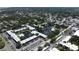 Aerial view displays a community pool, central ponds, assigned parking, and manicured landscaping at 14130 Rosemary Ln # 3202, Largo, FL 33774