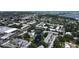 An aerial view showcases condos with a pool, pond, and beautiful landscaping in a tranquil community setting at 14130 Rosemary Ln # 3202, Largo, FL 33774