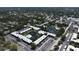 The aerial view of the condo shows central ponds, a swimming pool, parking, and beautiful landscaping at 14130 Rosemary Ln # 3202, Largo, FL 33774