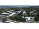 Aerial view of a condo complex featuring a central pond, fountain, and community pool near the ocean at 14130 Rosemary Ln # 3202, Largo, FL 33774