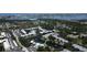 Aerial view of a condo community featuring a pond, swimming pool, and mature trees at 14130 Rosemary Ln # 3202, Largo, FL 33774