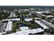 Aerial view of a condo complex featuring a central pond, fountain, and community pool at 14130 Rosemary Ln # 3202, Largo, FL 33774