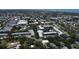 Aerial view of condo community featuring mature trees, swimming pools, ponds, and convenient parking at 14130 Rosemary Ln # 3202, Largo, FL 33774