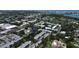 The aerial view showcases condos with a central pond, swaying trees, and a pool, offering a blend of nature and comfort at 14130 Rosemary Ln # 3202, Largo, FL 33774