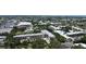 An aerial perspective of the serene lake, verdant trees, and shimmering pool at 14130 Rosemary Ln # 3202, Largo, FL 33774