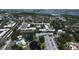 Overhead view showcasing community pool, pond, bridge, and lush landscaping at 14130 Rosemary Ln # 3202, Largo, FL 33774