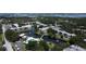 Discover condos with a serene pond, swaying trees, and a pool, offering a blend of nature and relaxation in this aerial view at 14130 Rosemary Ln # 3202, Largo, FL 33774