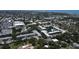 A serene aerial view showcases condos with a pond, swaying trees, and a pool, offering a blend of nature and relaxation at 14130 Rosemary Ln # 3202, Largo, FL 33774