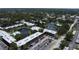 Aerial view of a condo complex featuring a central pond, fountain, and community pool at 14130 Rosemary Ln # 3202, Largo, FL 33774
