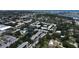 An aerial perspective features condos with a pond, swaying trees, and a pool, blending nature and relaxation in this retreat at 14130 Rosemary Ln # 3202, Largo, FL 33774
