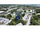 An aerial view of a condo community featuring a pond, swimming pool, and mature trees at 14130 Rosemary Ln # 3202, Largo, FL 33774