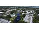 A serene aerial view highlights the condos nestled around a picturesque pond with a pool, providing a peaceful retreat at 14130 Rosemary Ln # 3202, Largo, FL 33774