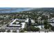 Overhead view showcases condominiums with mature trees, ponds with fountains, pools, and plenty of parking spaces at 14130 Rosemary Ln # 3202, Largo, FL 33774